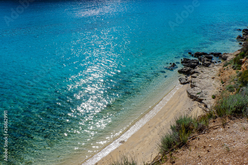 View from a beach during summer, located on a beautiful island of Rab on the Adriatic coast in the heart of Mediterranean sea. Surrounded by the crystal clear turquoise sea and blue sky. photo