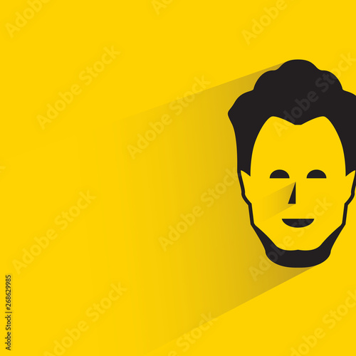 male face with shadow in yellow background