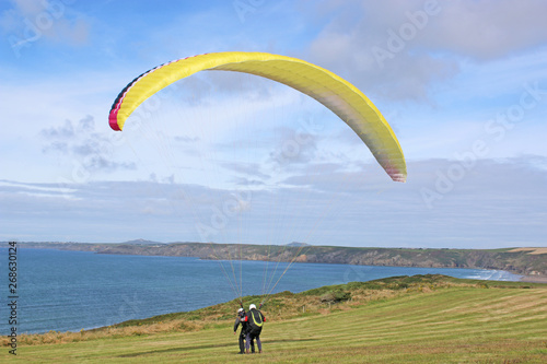 Tandem paraglider launching at Newgale Bay