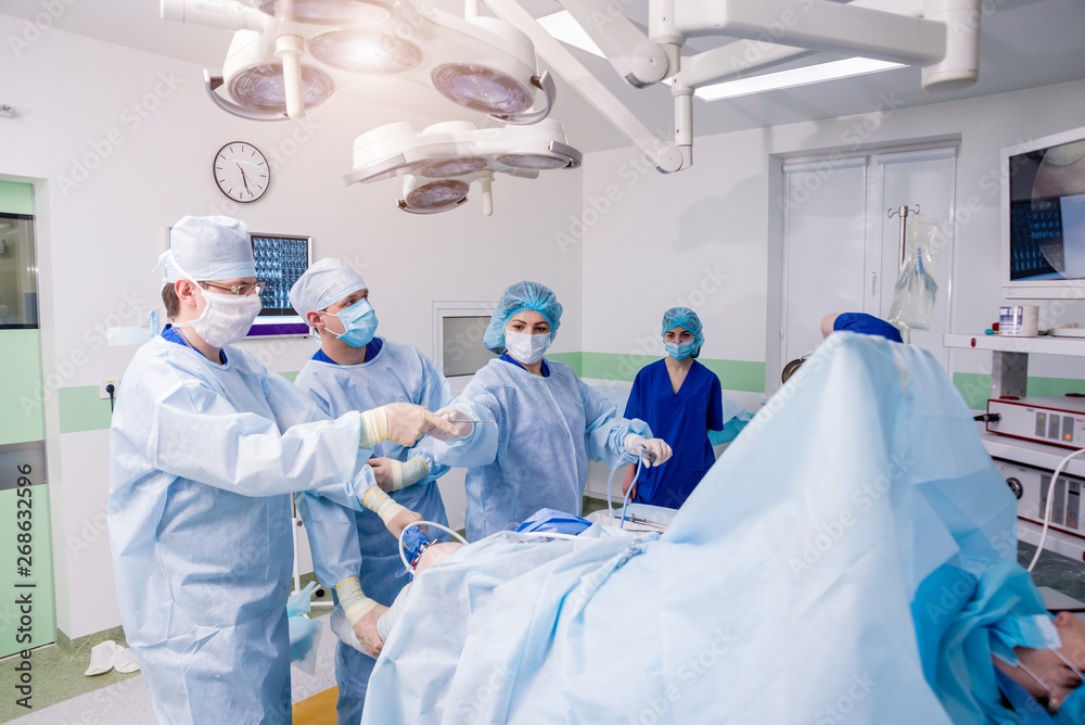 Arthroscope surgery. Orthopedic surgeons in teamwork in the operating room with modern arthroscopic tools. Knee surgery. Arthroscope surgery. Orthopedic surgeons in teamwork in the operating room with modern arthroscopic tools. Knee surgery.