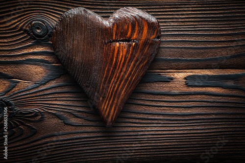 single vintage wood valentine toy heart on wooden board