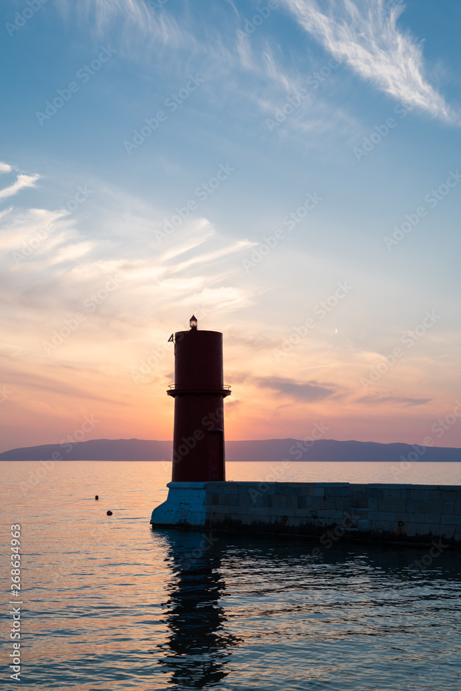 Sunset behind the red lighthouse in Cres