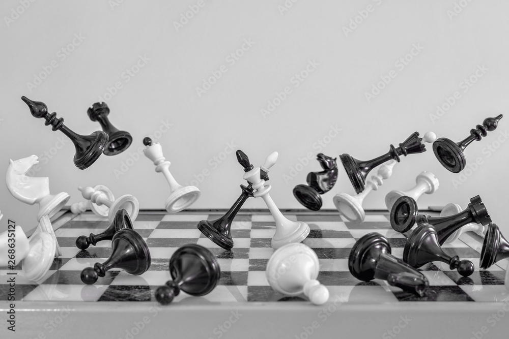 Chess pieces on a white background fly away from the center. Battle ...