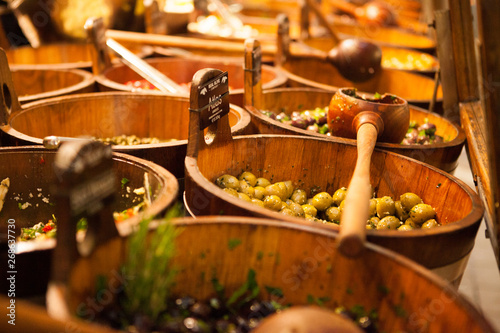 Bowls of various olives for sale at a market place