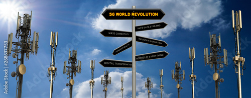 5G world revolution concept 3D sign on a signpost with a row of mobile telecommunication cell towers against a sunny blue sky background