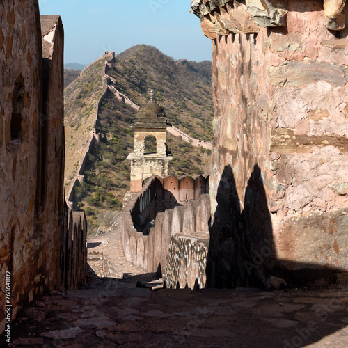 ancient watchtower in the great indian wall overlooking the city of Amer near to the Amber Fort, Radjasthan, Jaipur, India  photo