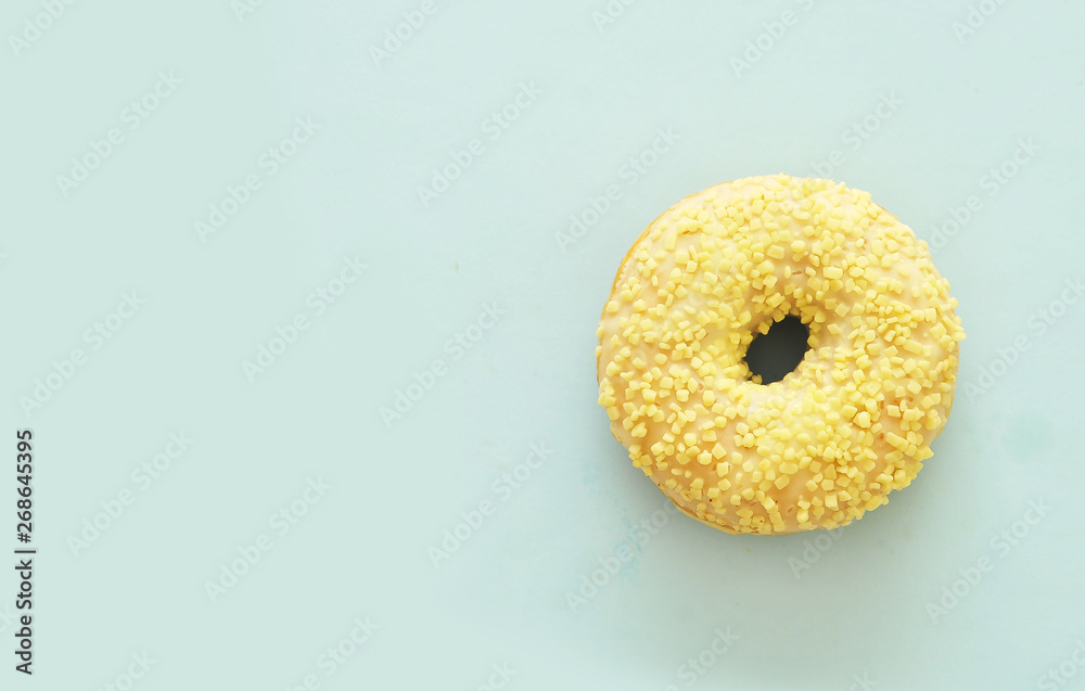 Delicious donuts on light pastel color background. National Donut Day concept.