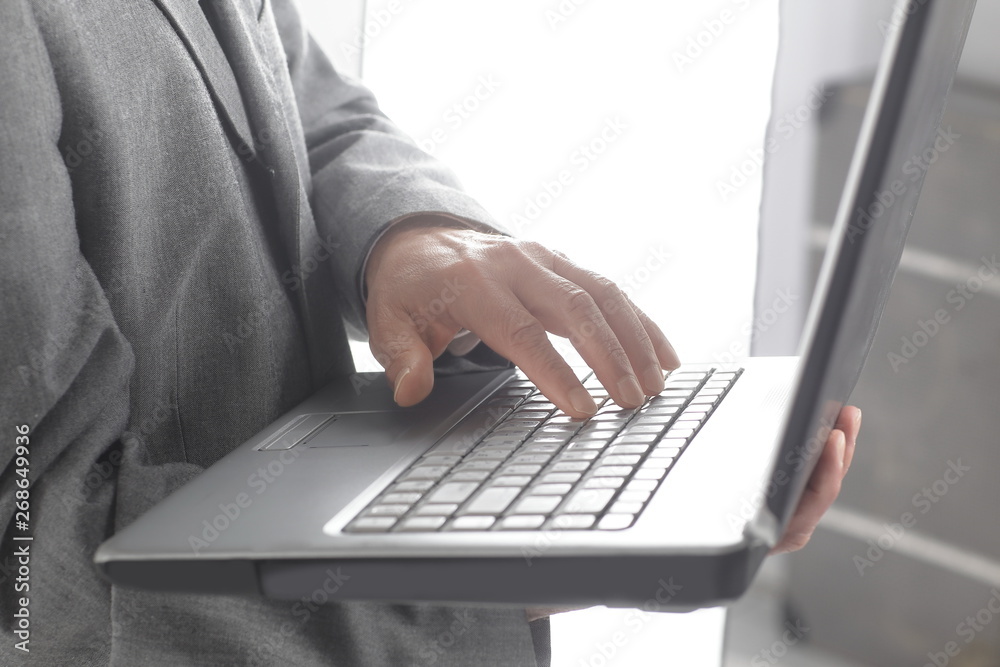 close up.businessman typing on a laptop keyboard.isolated on white background close up.businessman typing on a laptop keyboard.isolated on white background