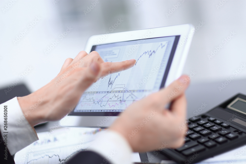 close up.businessman pointing at digital tablet screen close up.businessman pointing at digital tablet screen
