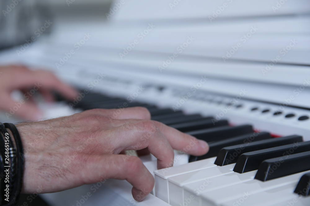 Fototapeta premium hands playing the white piano