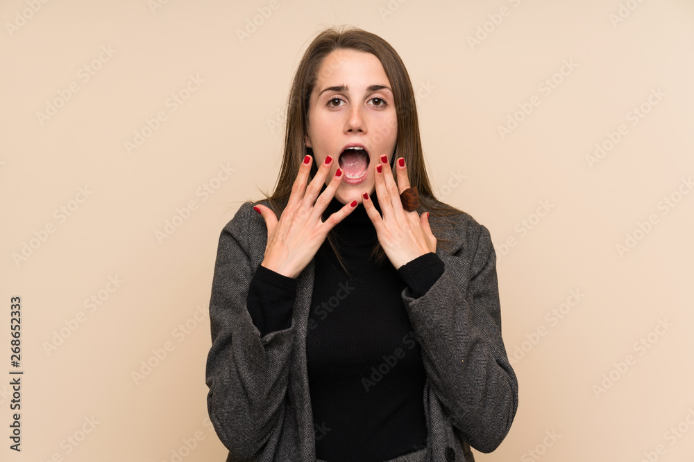 Young woman over isolated wall with surprise facial expression Young woman over isolated wall with surprise facial expression