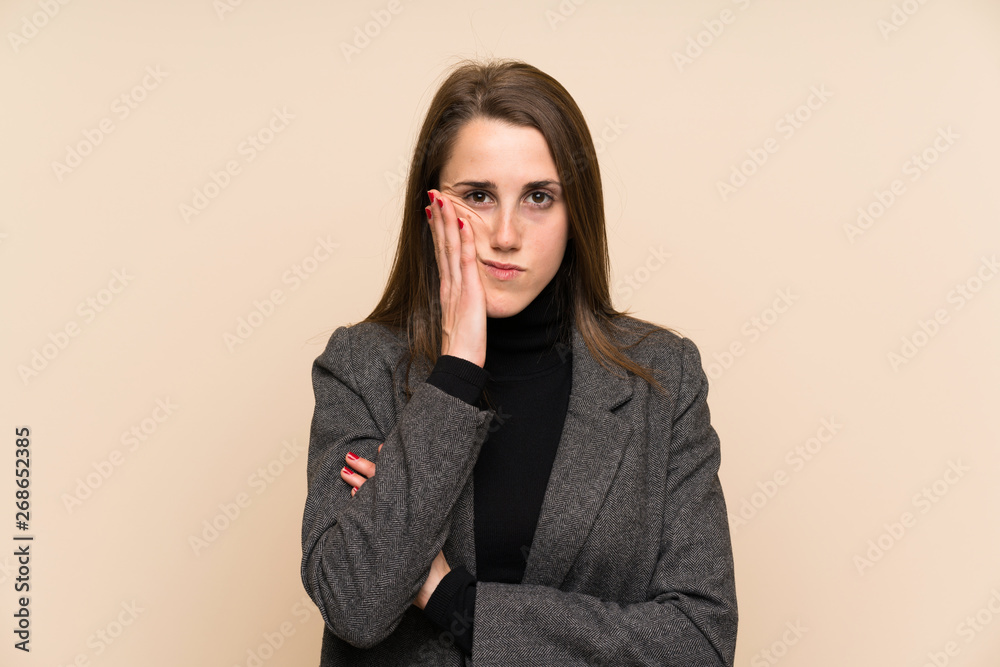 Young woman over isolated wall unhappy and frustrated Young woman over isolated wall unhappy and frustrated