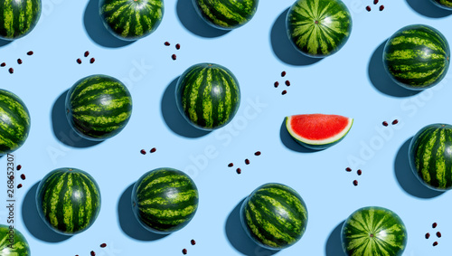 Fototapeta Naklejka Na Ścianę i Meble -  One out unique watermelons arranged on a blue background