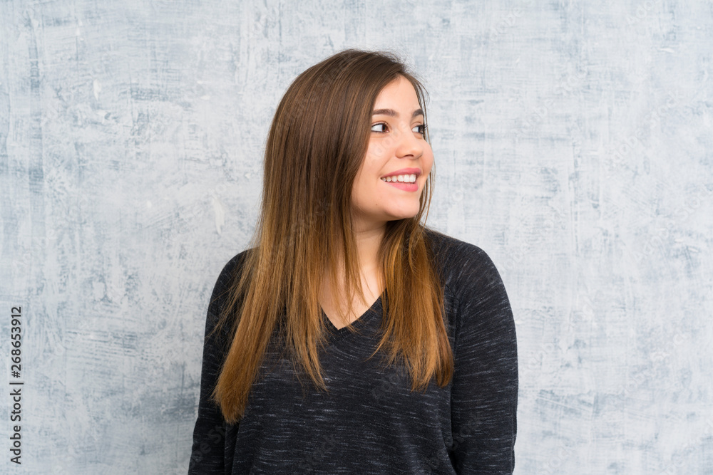 Fototapeta premium Young girl over grunge wall laughing
