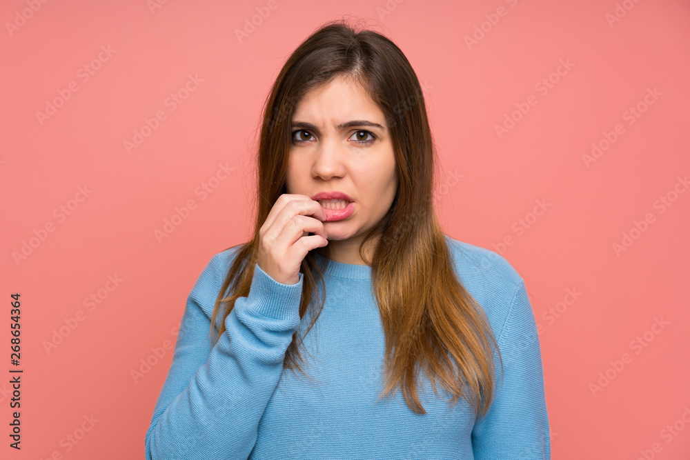 Fototapeta premium Young girl with blue sweater nervous and scared