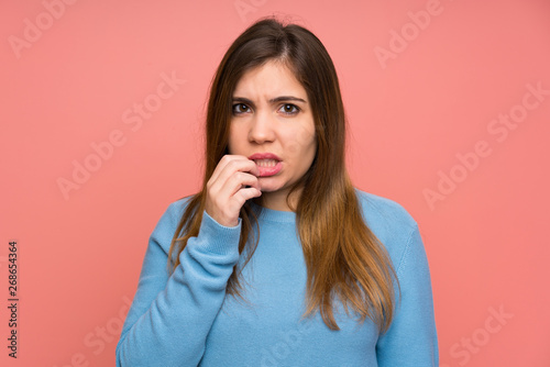 Young girl with blue sweater nervous and scared