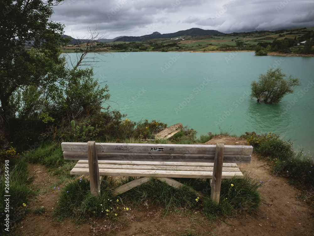 Wooden bench with a view of a flooded land