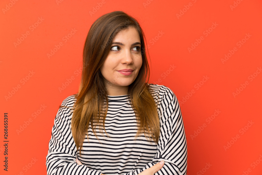 Young girl with striped shirt standing and looking to the side Young girl with striped shirt standing and looking to the side