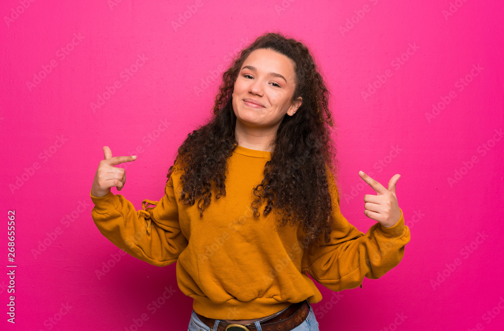 Teenager girl over pink wall proud and self-satisfied Teenager girl over pink wall proud and self-satisfied