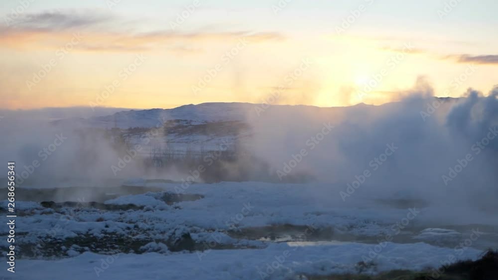 Mist from waterfall in Iceland at sunrise in winter Mist from waterfall in Iceland at sunrise in winter