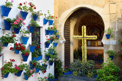 Our lady of Bethlehem and Shepherds Chapel with flower pots in courtyard during Spring festival Cordoba
