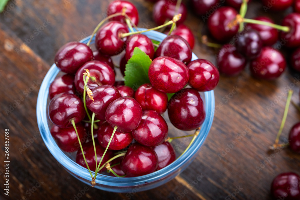 cherry in glass plate with wooden background. cherry in glass plate with wooden background.