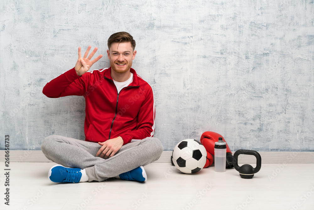 Redhead sport man happy and counting four with fingers Redhead sport man happy and counting four with fingers