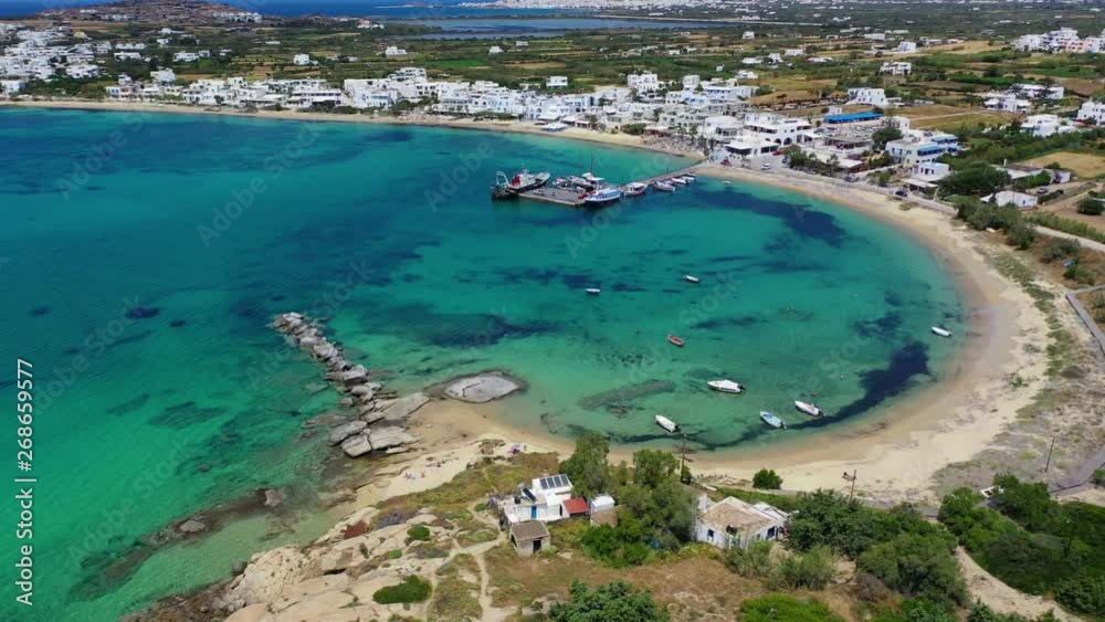 Aerial drone video of breathtaking turquoise round sandy beach and small village and small seaside picturesque chapel of Agia Anna, Naxos island, Cyclades, Greece Aerial drone video of breathtaking turquoise round sandy beach and small village and small seaside picturesque chapel of Agia Anna, Naxos island, Cyclades, Greece