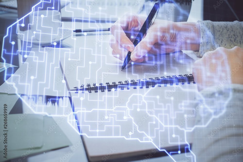 Double exposure of writing hand on background with brain hologram. Concept of learning. Double exposure of writing hand on background with brain hologram. Concept of learning.