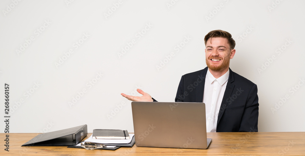 Businessman in a office holding copyspace imaginary on the palm to insert an ad