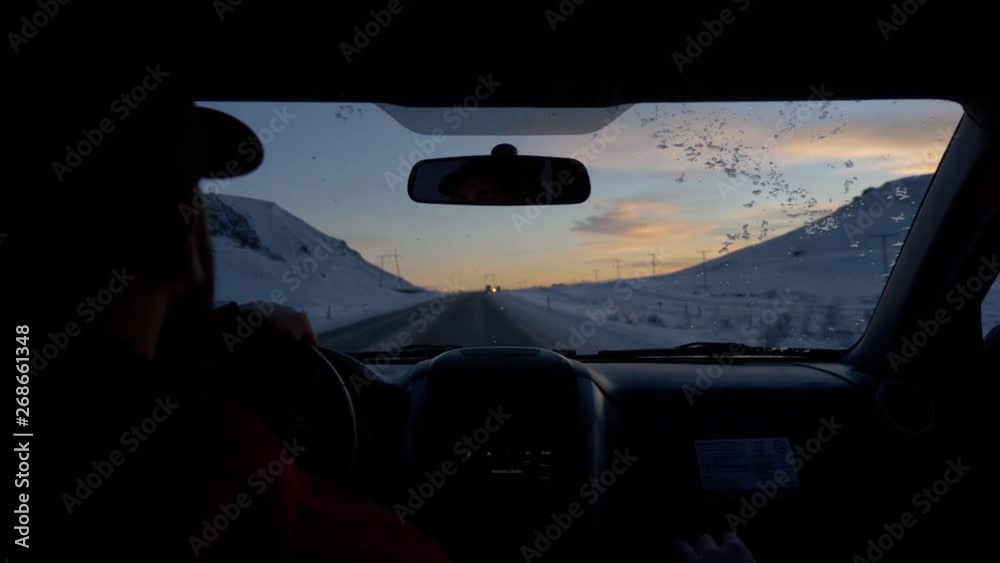 Driving at sunrise in Iceland in winter on road