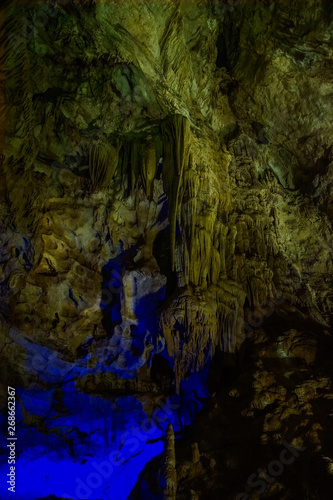 illuminated stalagmites in Prometheus Cave