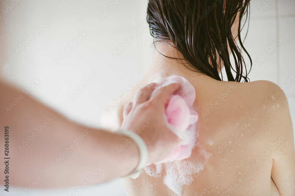 Man's hand washing the back of a slim and sexy young woman in the shower -  couple taking care of each other - POV picture, follow me concept Stock  Photo | Adobe Stock