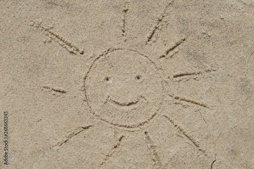 smiling sun on sand drawing