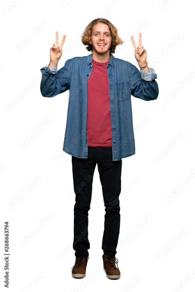 Full-length shot of Blonde man showing victory sign with both hands over isolated white background Full-length shot of Blonde man showing victory sign with both hands over isolated white background