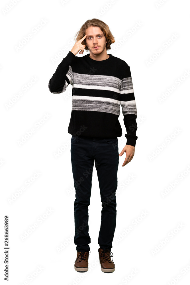 Full-length shot of Blonde man making the gesture of madness putting finger on the head over isolated white background