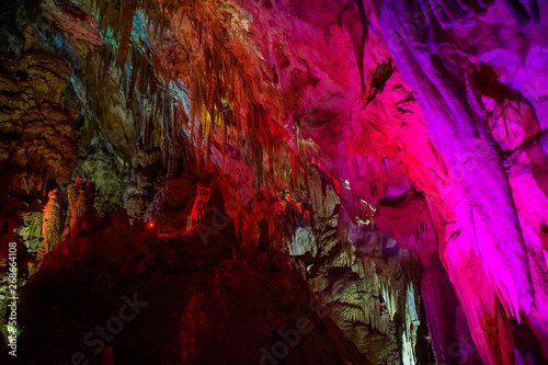 pink illuminated formations in Prometheus Cave