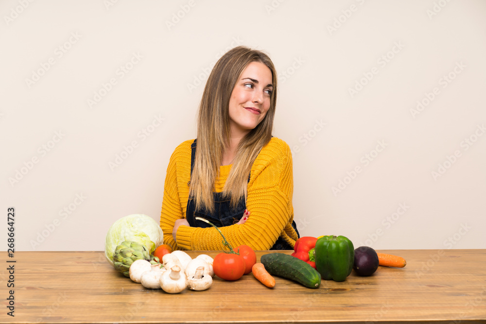 Fototapeta premium Woman with lots of vegetables laughing
