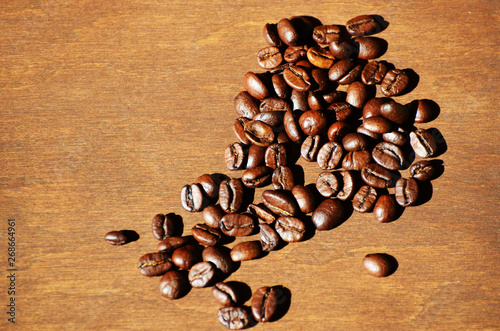 Close-up coffee beans on wooden background, aroma photo