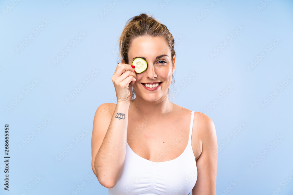 Happy Beautiful young woman holding slices of cucumber Happy Beautiful young woman holding slices of cucumber