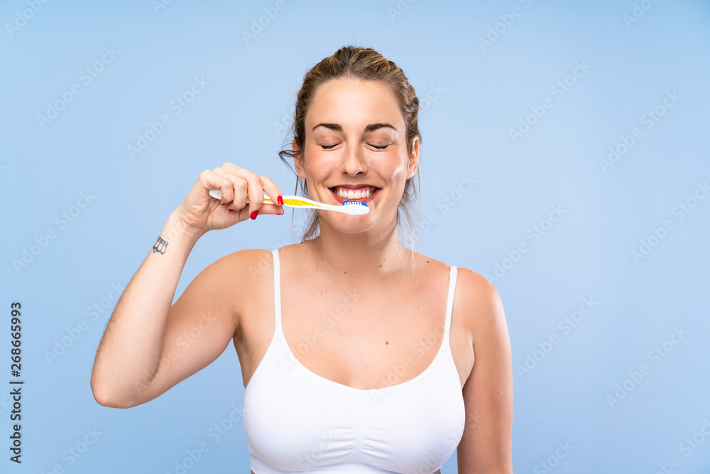 Happy Young blonde woman brushing her teeths Happy Young blonde woman brushing her teeths