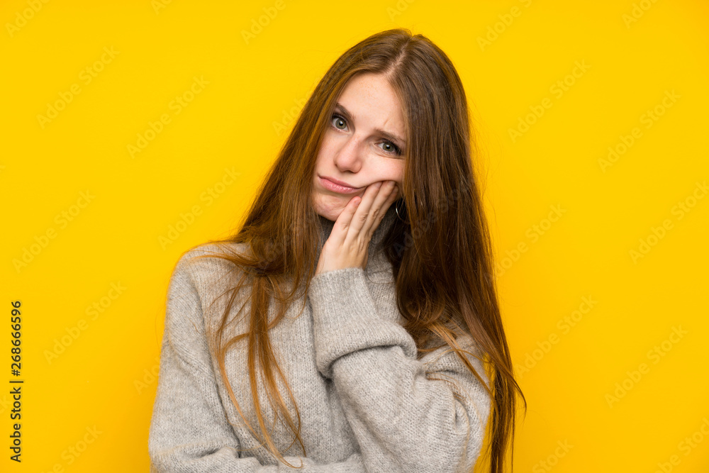 Young woman with long hair over yellow background unhappy and frustrated Young woman with long hair over yellow background unhappy and frustrated