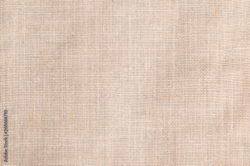 Hessian sackcloth woven texture pattern background in light cream beige brown color