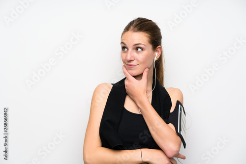 Young sport woman over isolated white background thinking an idea