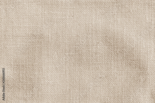 Hessian sackcloth woven fabric texture background in beige cream brown color