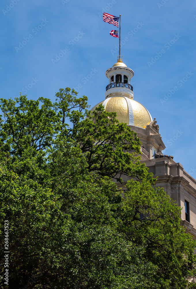 The gold dome and flag on the Savannah City Hall