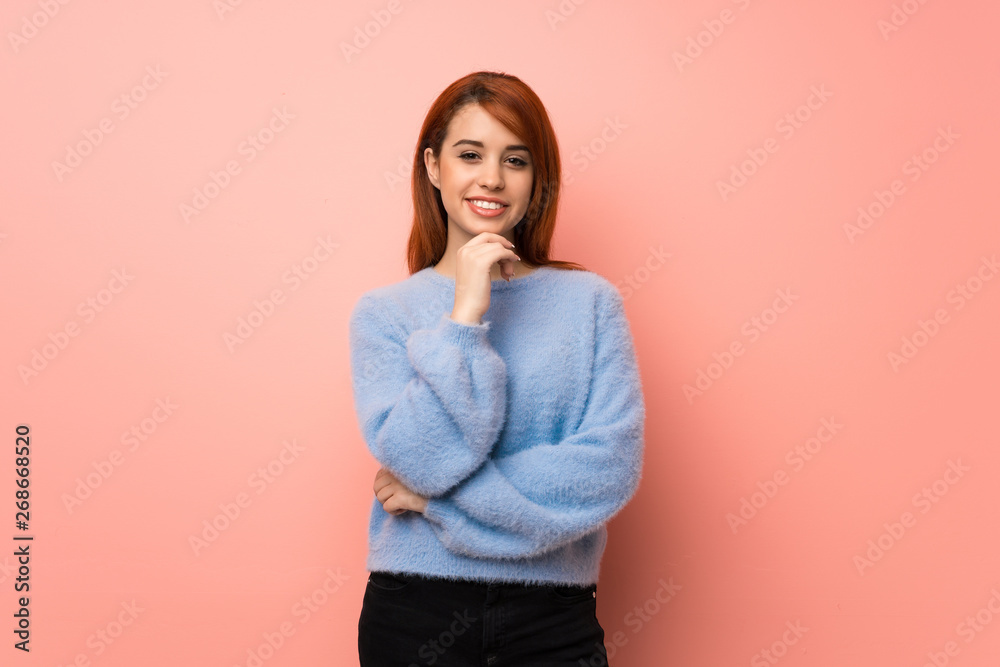 Young redhead woman over pink background smiling and looking to the front with confident face Young redhead woman over pink background smiling and looking to the front with confident face