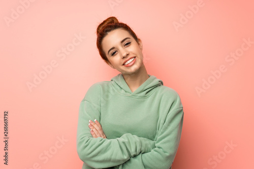 Wallpaper Mural Young redhead woman with sweatshirt keeping the arms crossed in frontal position Torontodigital.ca