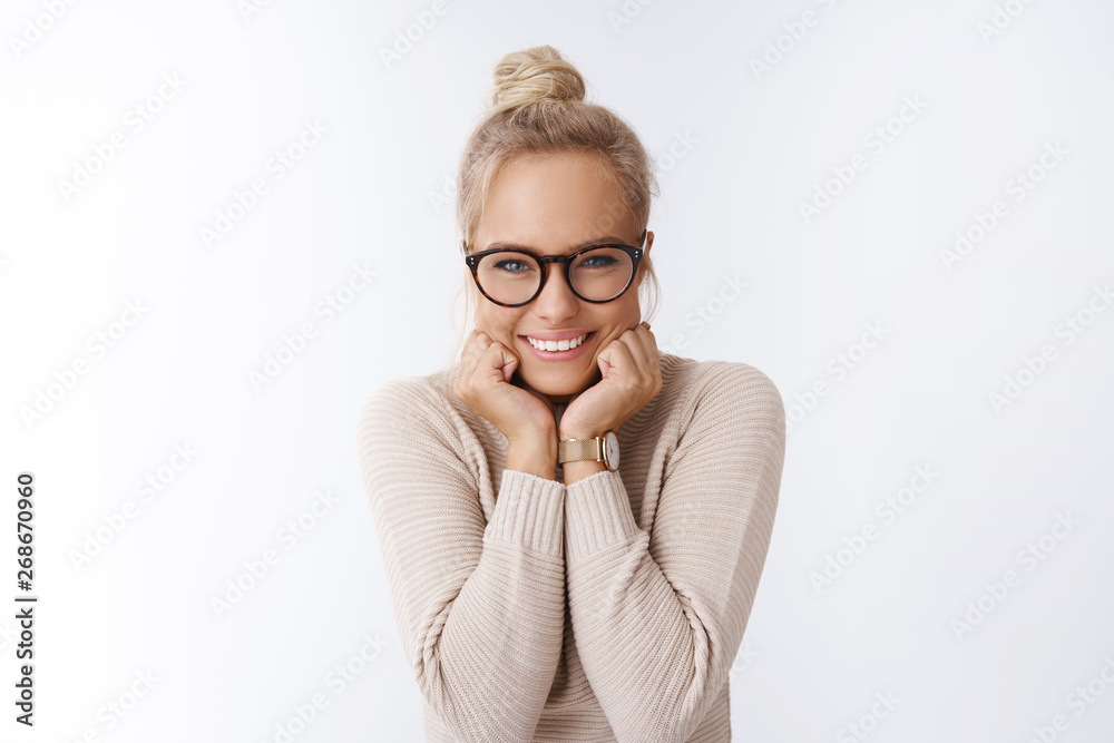 Flirty attractive glamour young woman giggling with girlfriend during coffee break discussing last rumors leaning face on palms smiling sassy and cute feeling upbeat and happy over white background