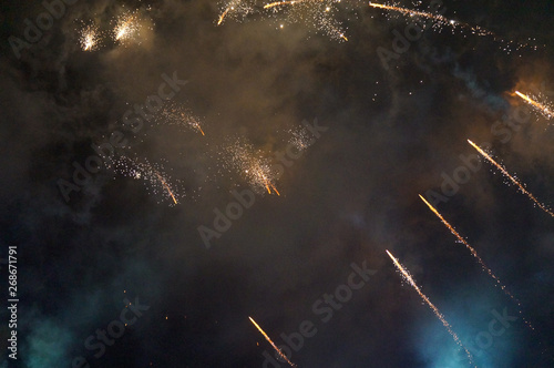 golden fireworks with smoke in blue background                               
